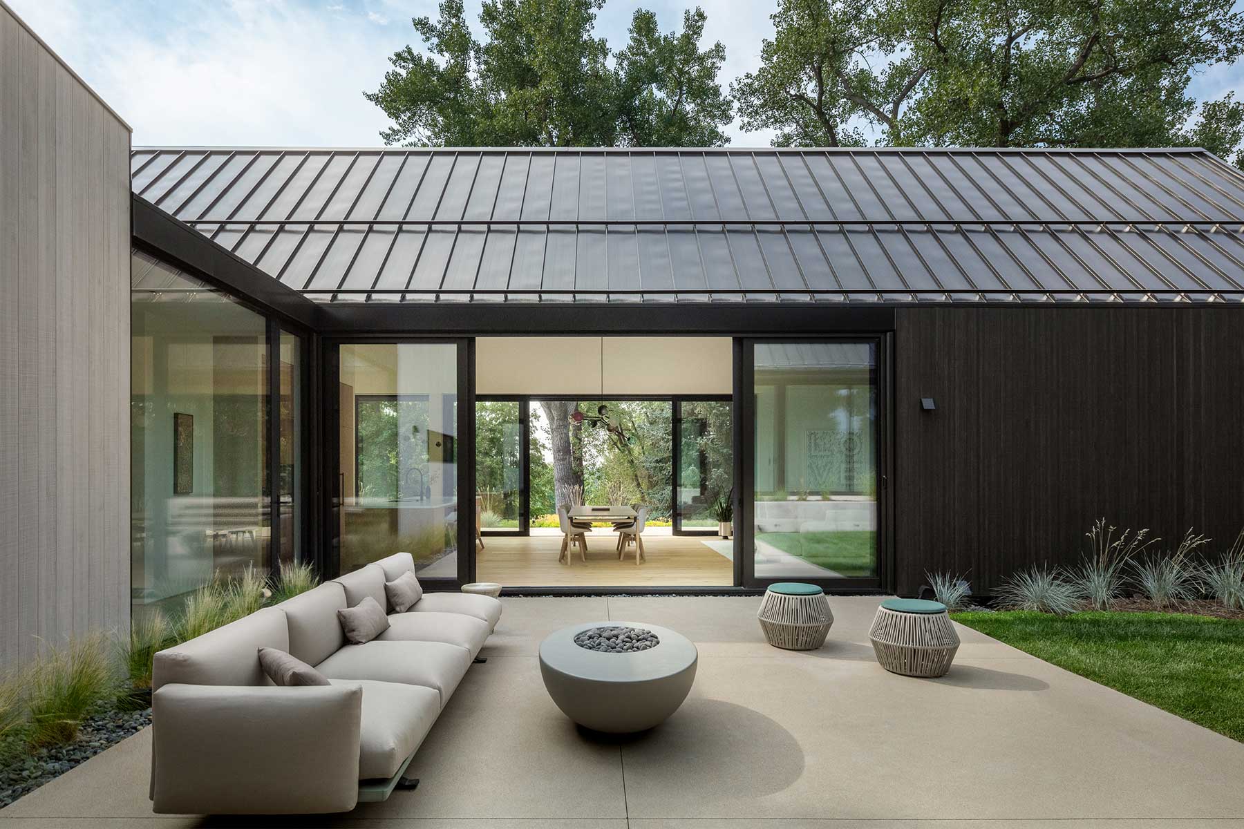Custom home with glassed dining room between wings.